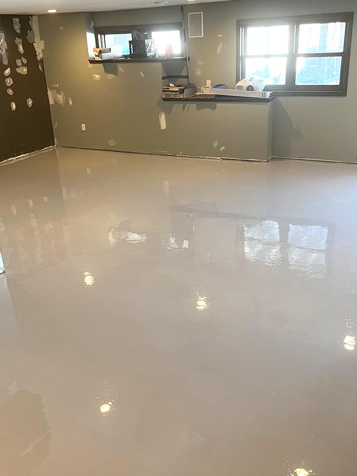 Residential basement with light grey high-gloss epoxy floor