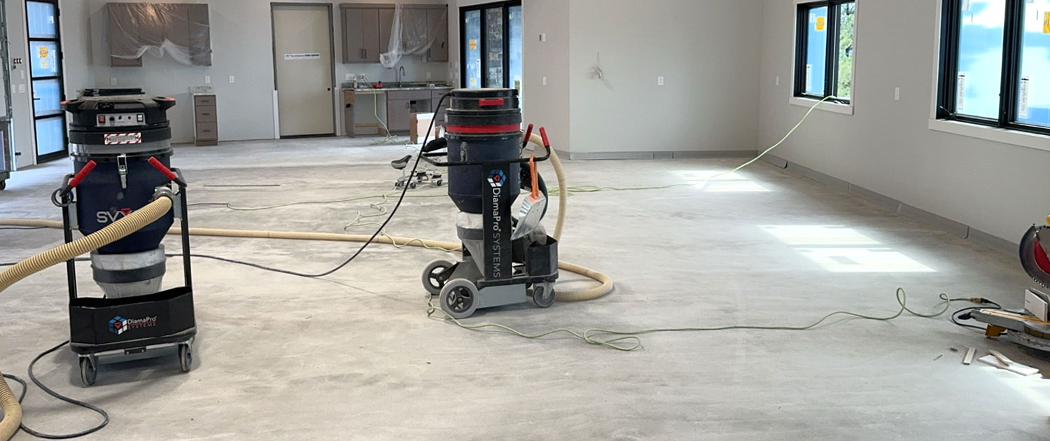 Large interior space being ground and polished with vacuums for a polished concrete finish